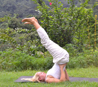 yoga poses - Liisa demonstrating a modified version of sarvangasana